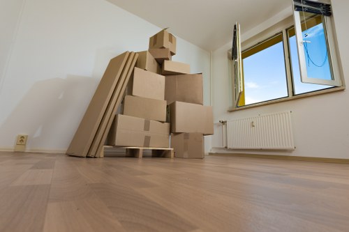 Moving team preparing boxes safely beside a van