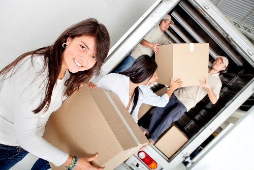 Delivery team handling a large item during transport